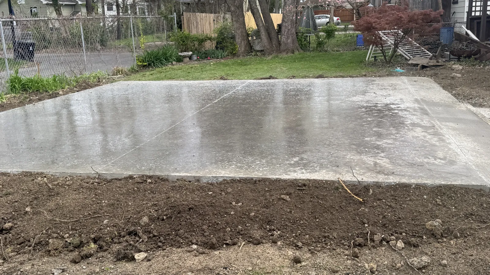 New concrete slab poured behind a house in an established neighborhood, concrete contractor serving Lyndon, KY