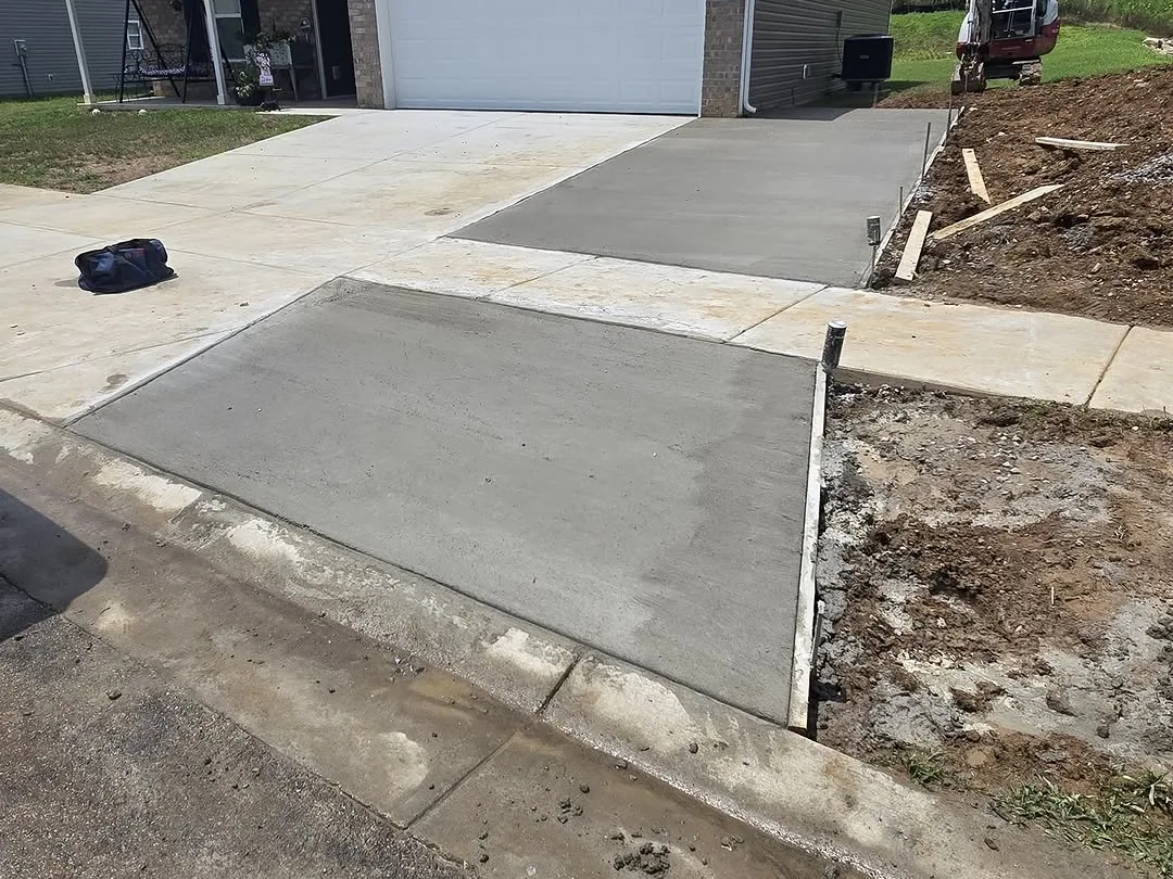 Widened concrete driveway and new apron in front of a garage, concrete driveways