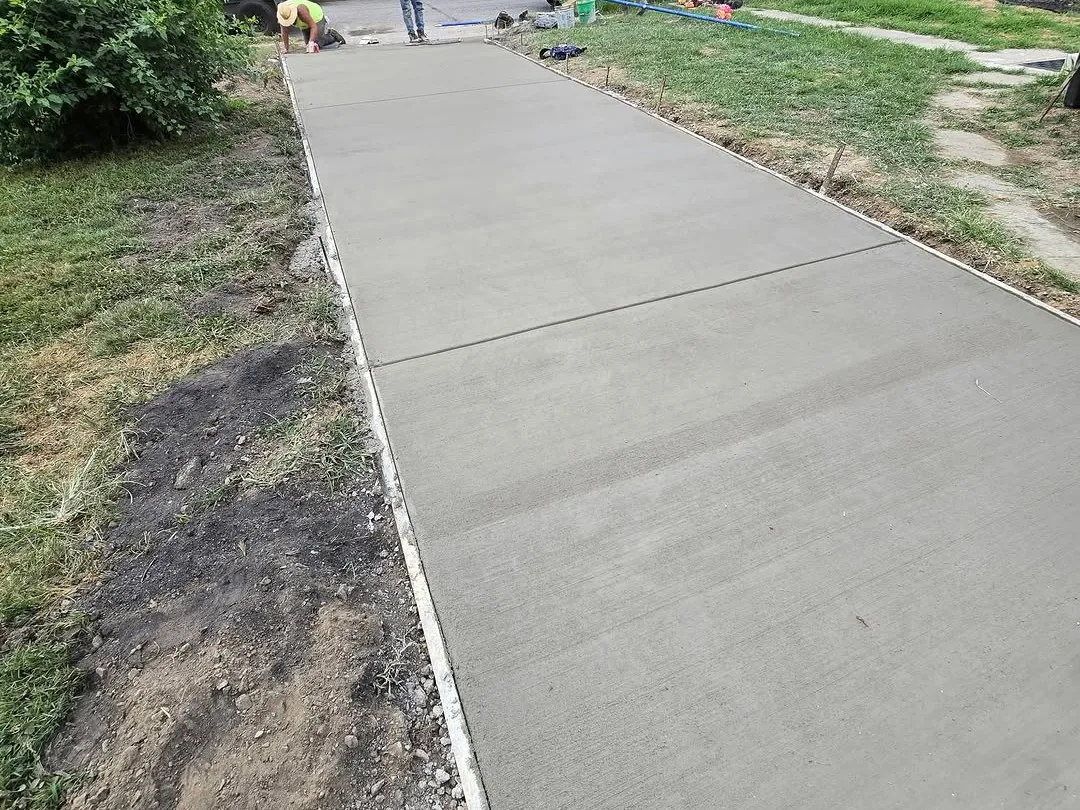 New broom finished concrete sidewalk with the crew working at the far end, concrete sidewalks
