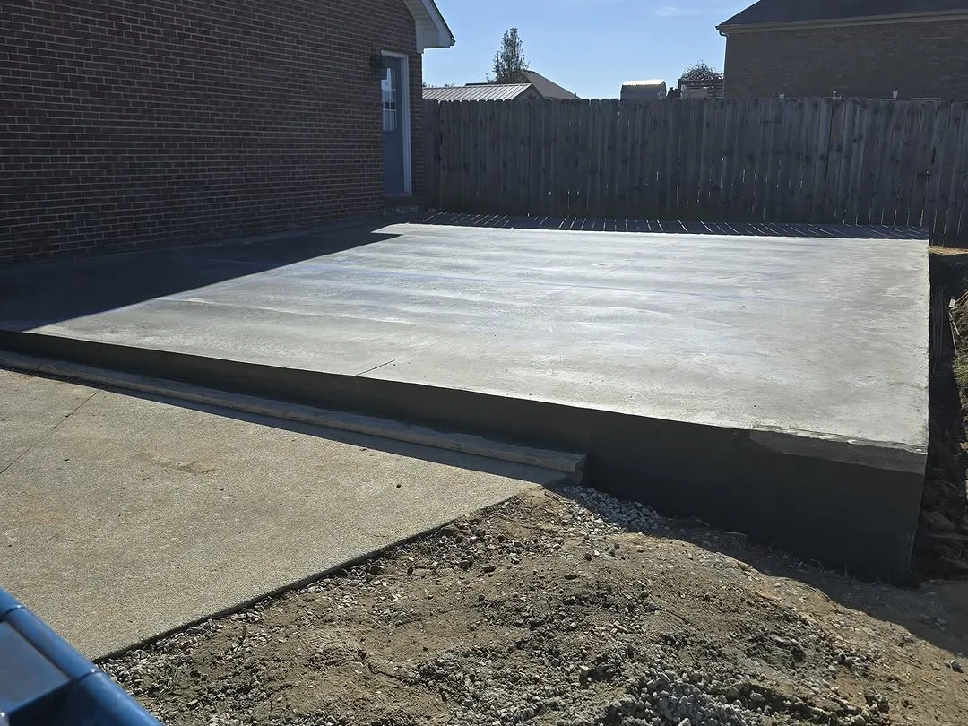 New concrete slab for a garage beside a brick house, concrete slabs