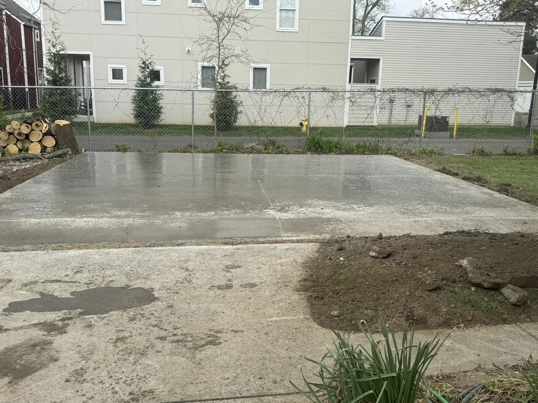 Large new concrete slab behind a row of homes, concrete slabs