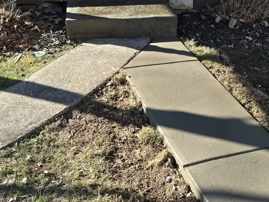 New concrete walk leading up to a step at a doorway, concrete steps